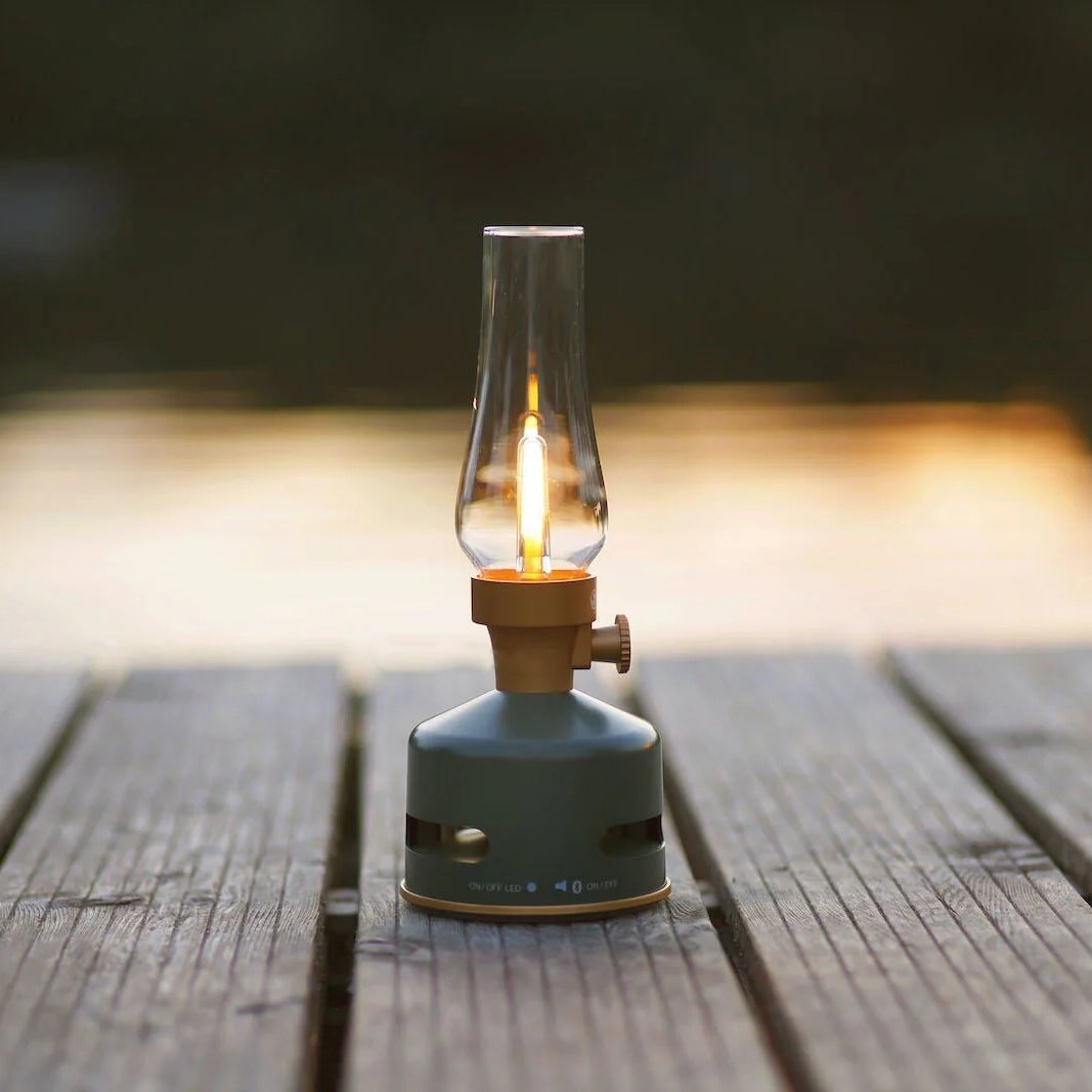 Light and Sound LED Lantern with Speaker in Basil on a dock with a lake in the background at Addison West