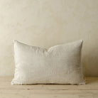 Lina Linen Lumbar Pillow in Chambray on a wood floor in front of a beige wall at Addison West