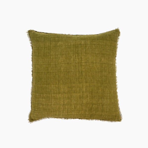 Moss green linen pillow with frayed edges on a white background