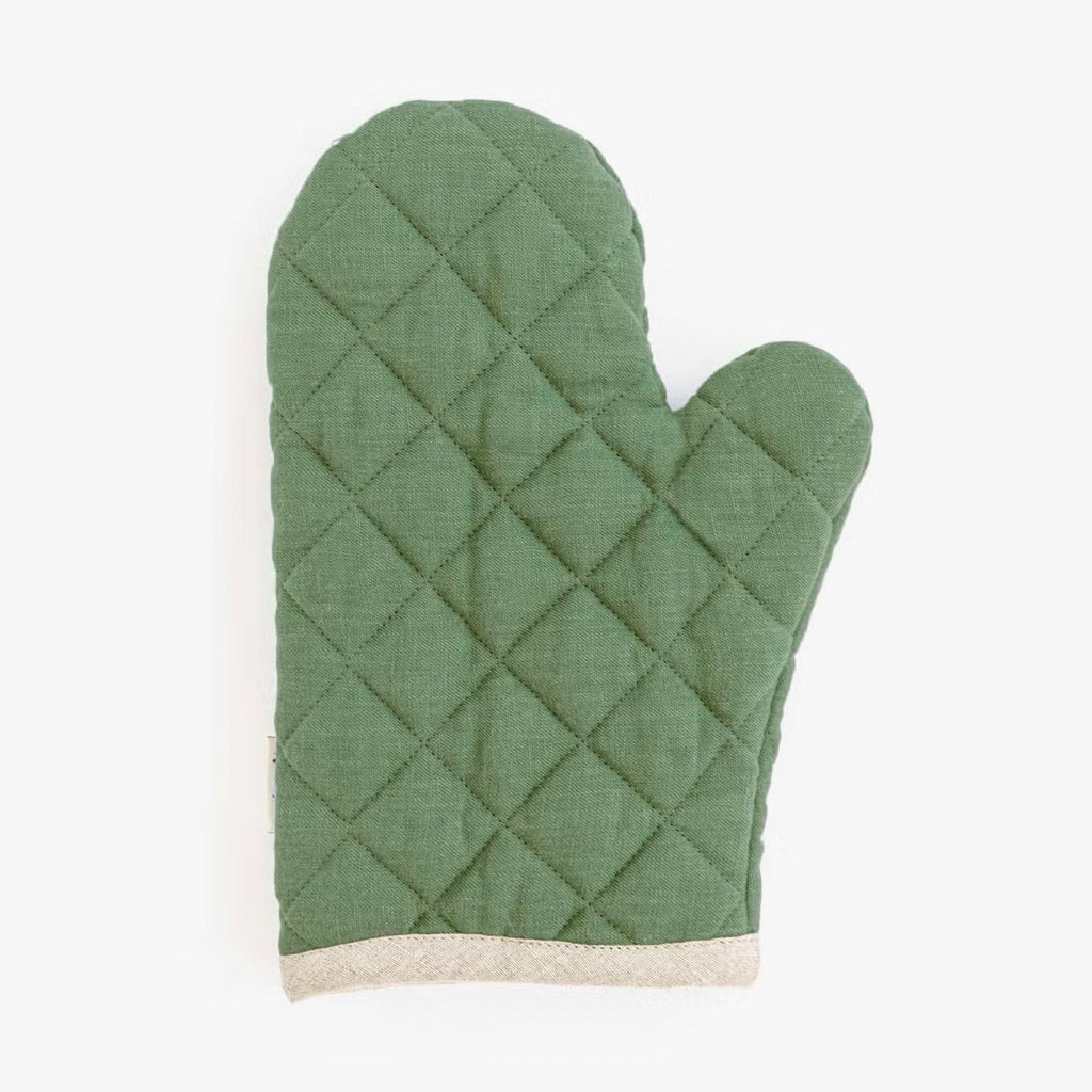 Linen oven mitt in green with quilting and natural linen trim on a white background