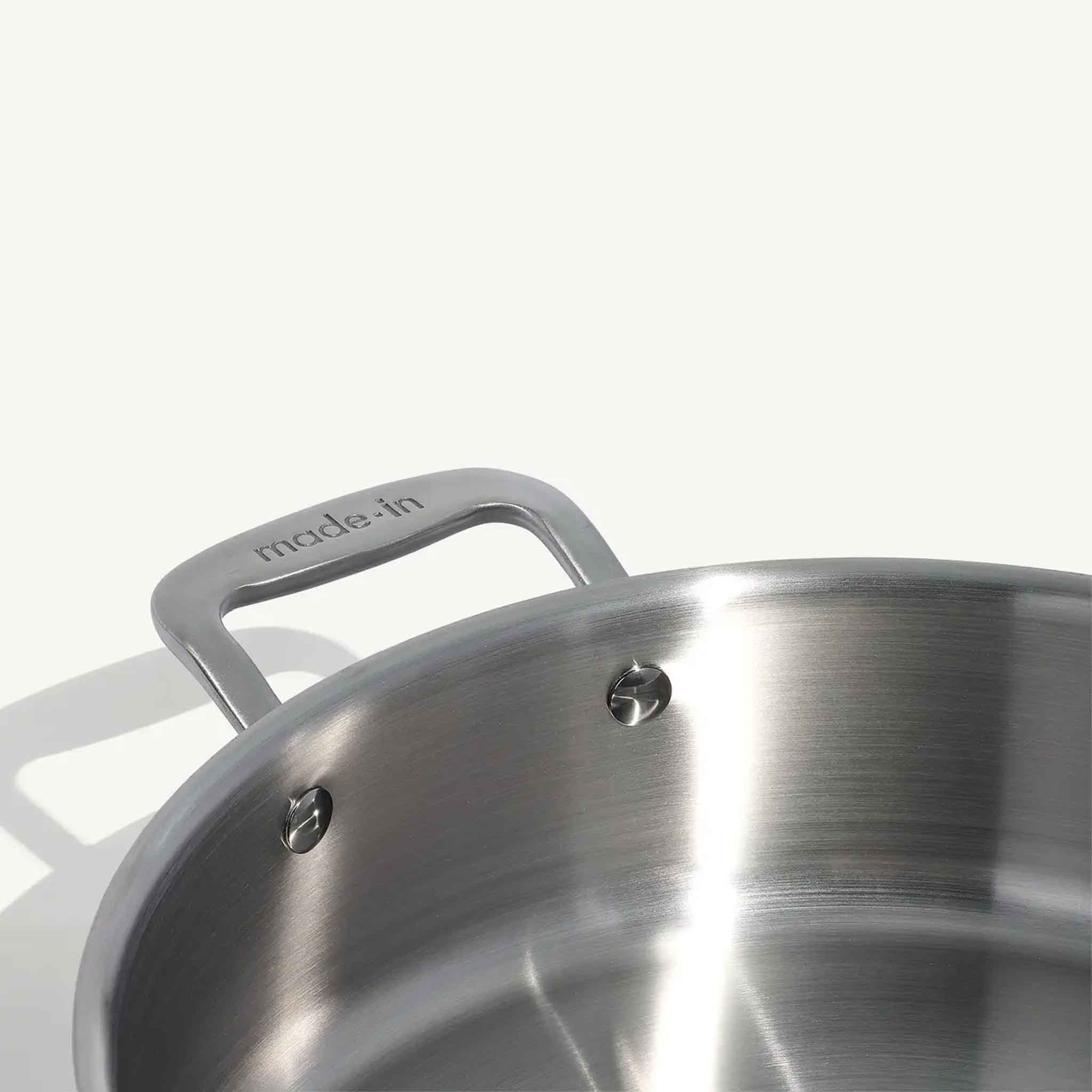 Close up of Made In Stainless Clad 6 qt. Rondeau with Lid on a beige background at Addison West