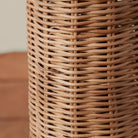 Close up of Woven Augusta Floor Lamp on a beige background at Addison West
