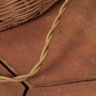 Close up of Woven Augusta Floor Lamp on a beige background at Addison West