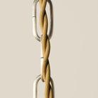 Close up of Augusta Chandelier on a beige background at Addison West