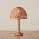 Augusta Mini Table Lamp on a beige background and wood table
