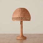 Augusta Mini Table Lamp on a beige background and wood table