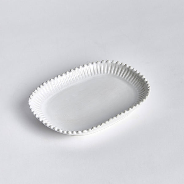 Small white rectangular tray with scalloped edges on a white background