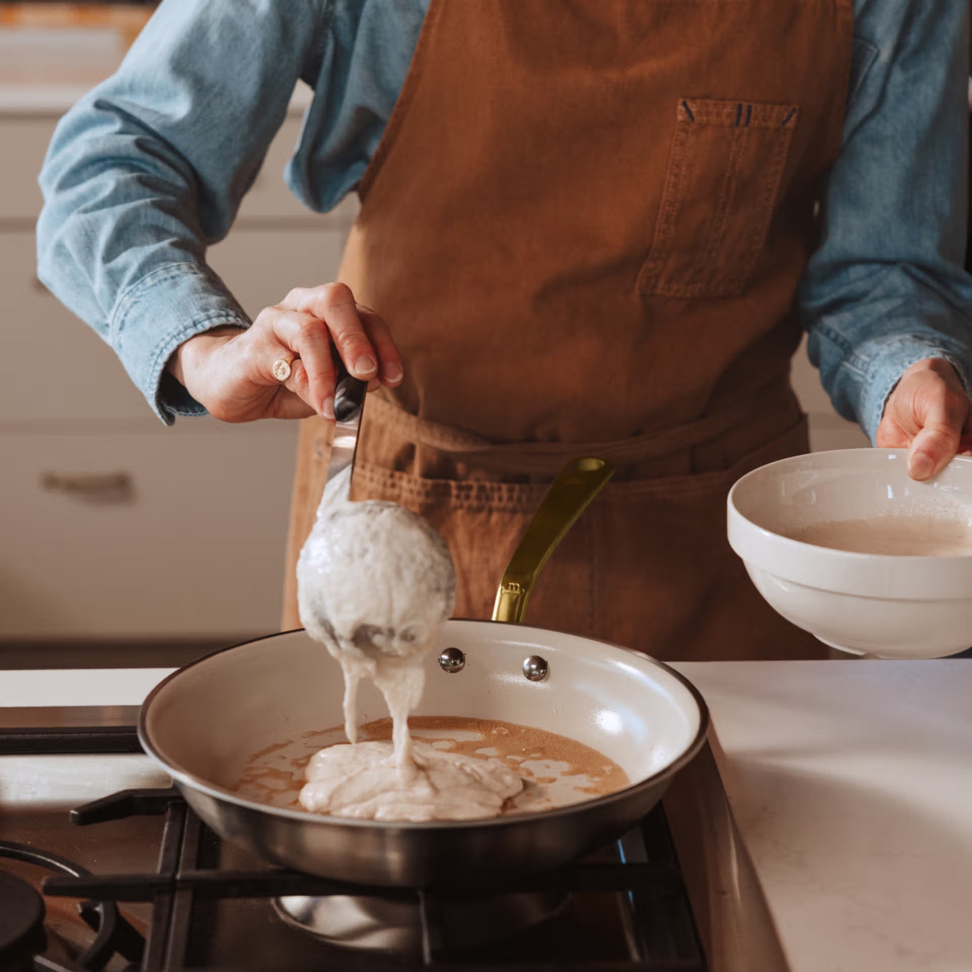 Made In CeramiClad™ 8” Non-stick Fry Pan in Antique Brass on a stove at Addison West