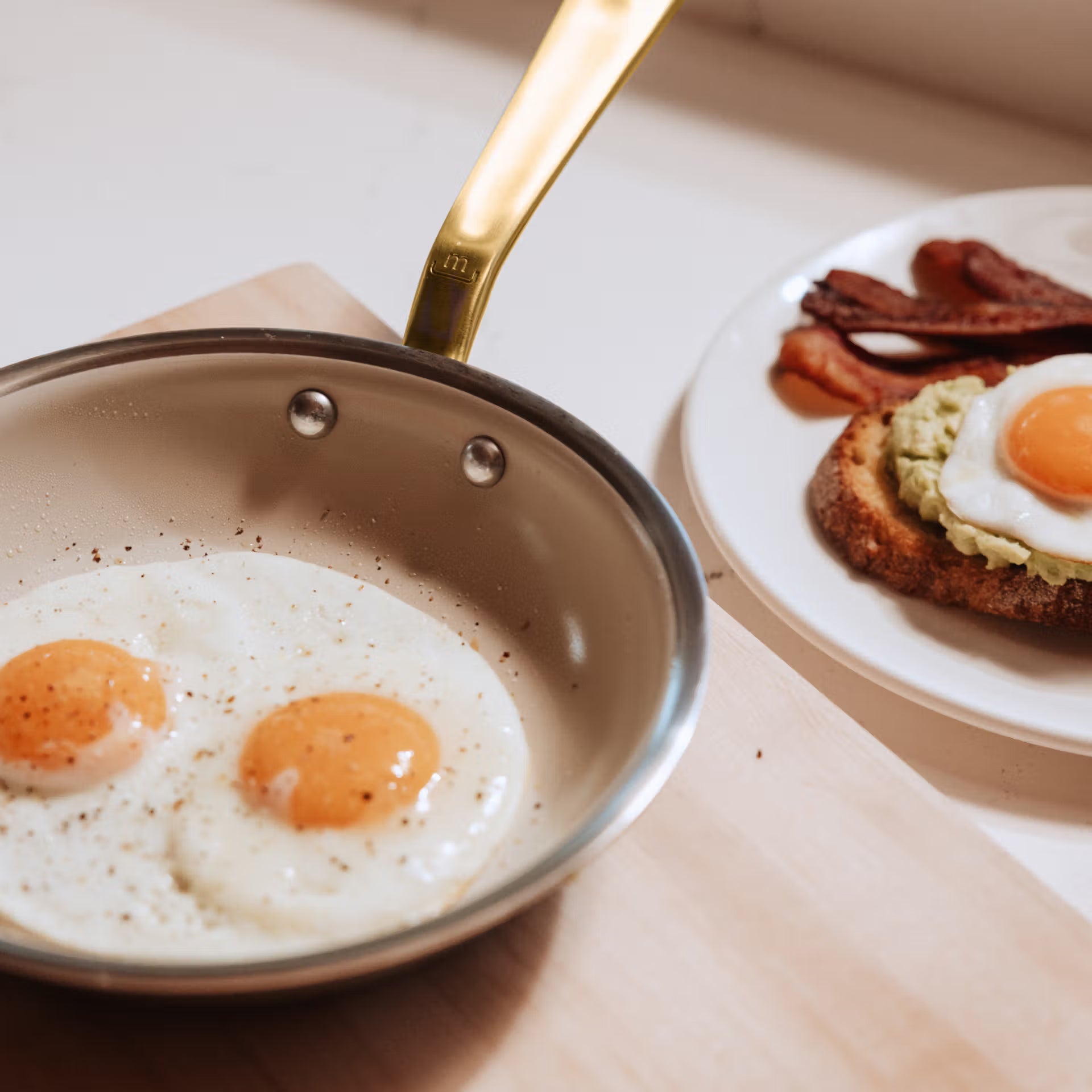 Made In CeramiClad™ 8” Non-stick Fry Pan in Antique Brass on a table at Addison West