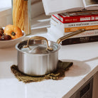 Made In Stainless Clad 2 qt. Saucepan with Lid in Antique Brass on a kitchen counter at Addison West