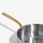 Made In Stainless Clad 3 qt. Saucier with Lid in Antique Brass on a white background at Addison West