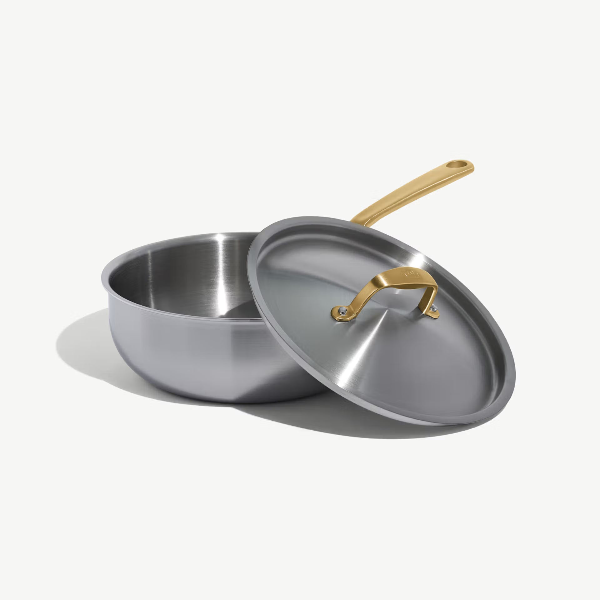 Made In Stainless Clad 3 qt. Saucier with Lid in Antique Brass on a white background at Addison West