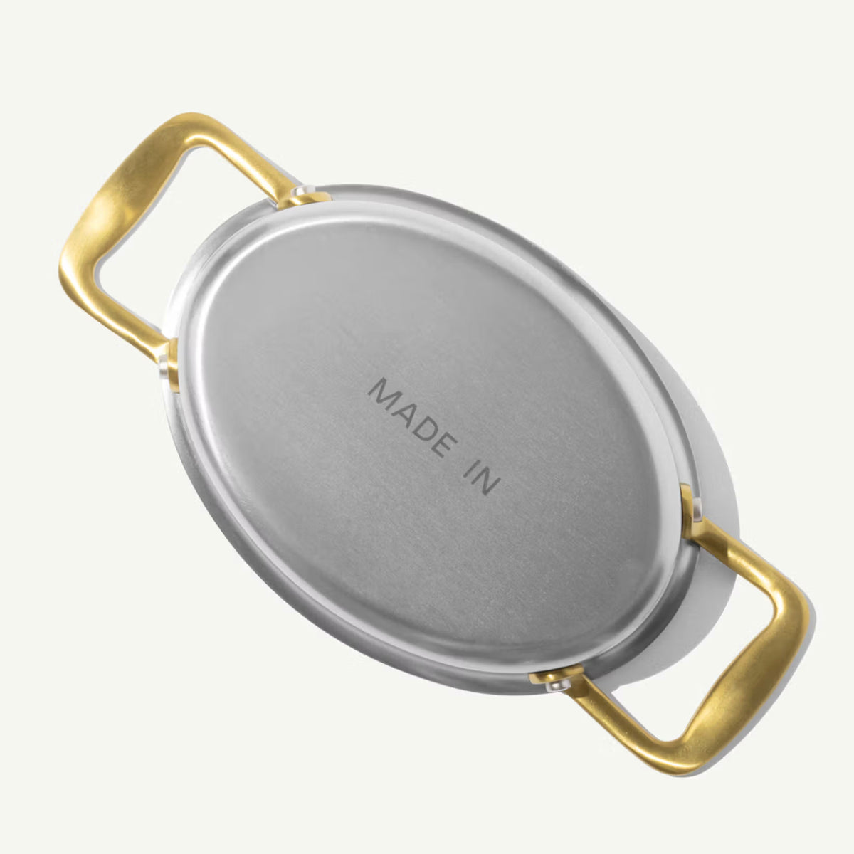 Made In Stainless Steel Gratin Dishes in Antiqued Brass on plain background.