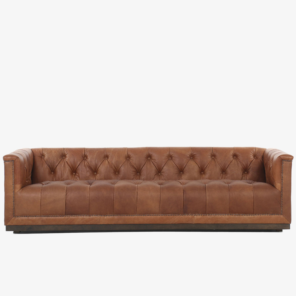 Four Hands furniture brand Maxx Chesterfield style Sofa in Heirloom Sienna leather on a white background
