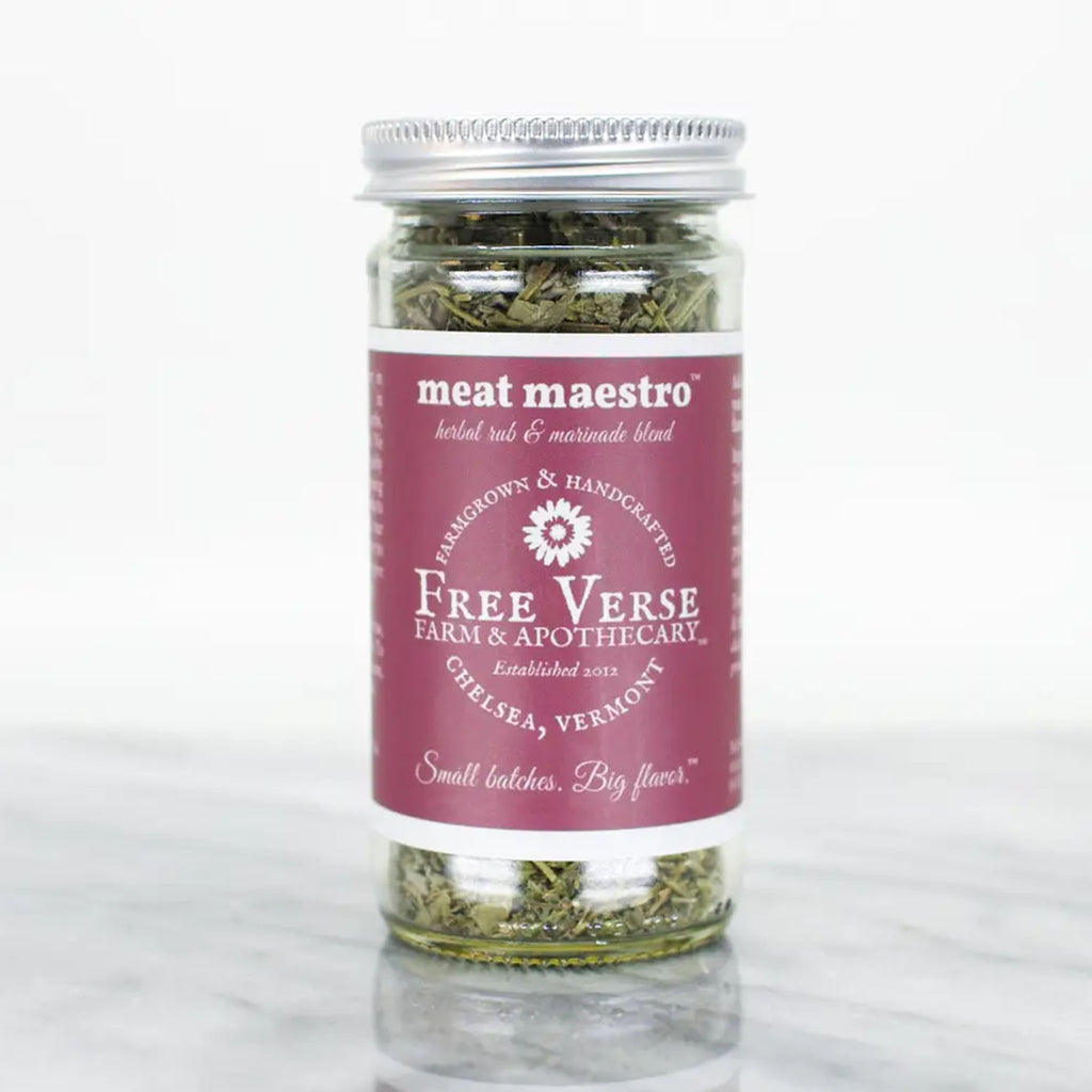 Free Verse farm meet maestro herb marinade blend in glass jar with red label on a marble surface