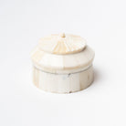 Round white bone box with layered rotunda shape on a white background