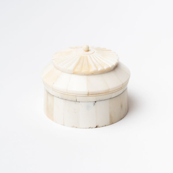 Round white bone box with layered rotunda shape on a white background