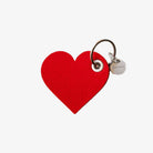 Red heart-shaped keychain with a tag on a white background