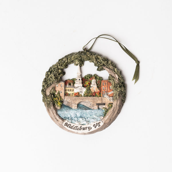 Handmade painted ornament with scene of Middlebury Vermont and waterfall on a white background