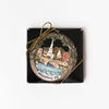 Handmade painted ornament with scene of Middlebury Vermont and waterfall in a box on a white background