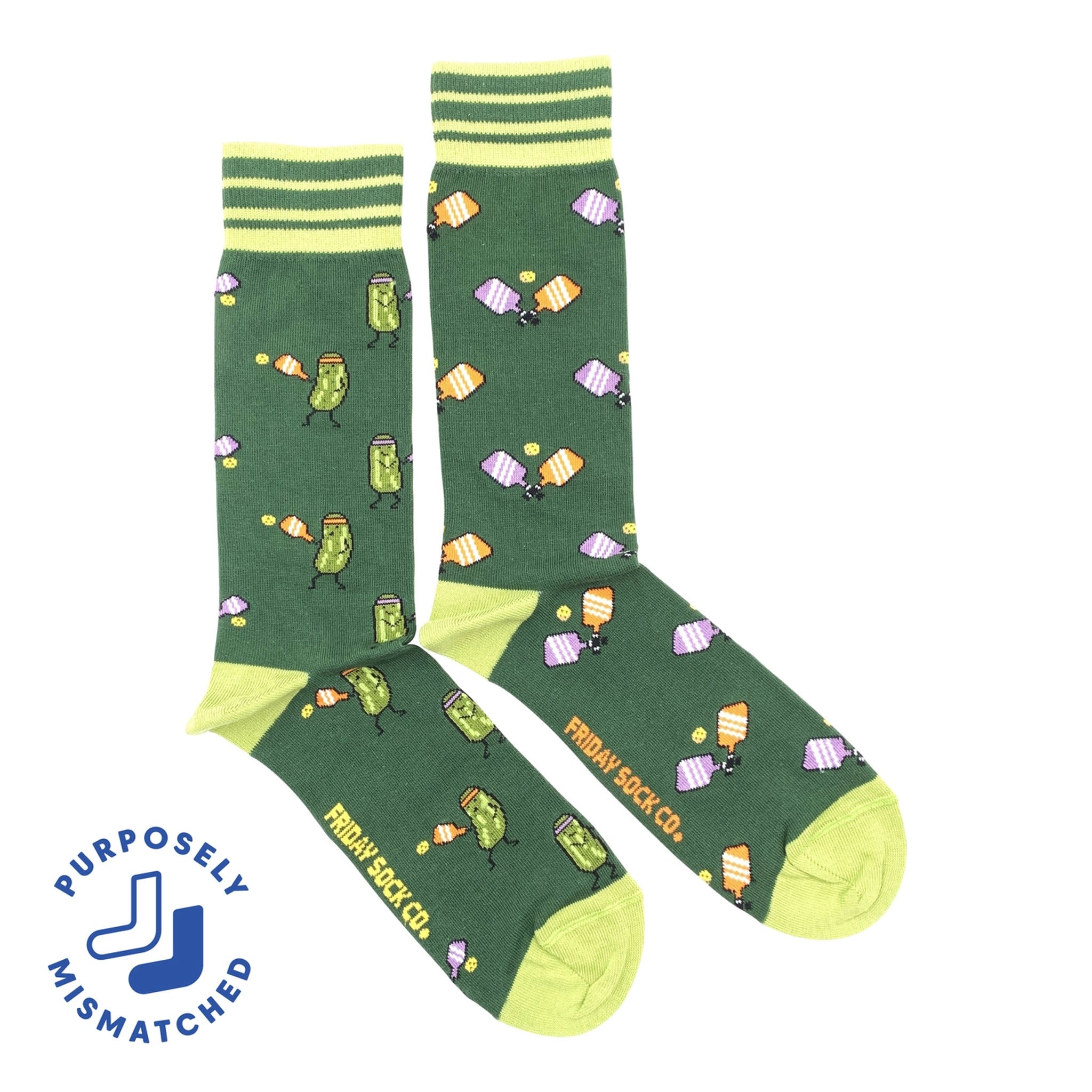 A pair of green men's socks with pickleball-themed patterns including pickleball paddles, balls, and court lines. The socks have ' PURPOSELY MISMATCHED ' text on the side.