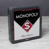 Black and white monopoly tin game box on a wood surface