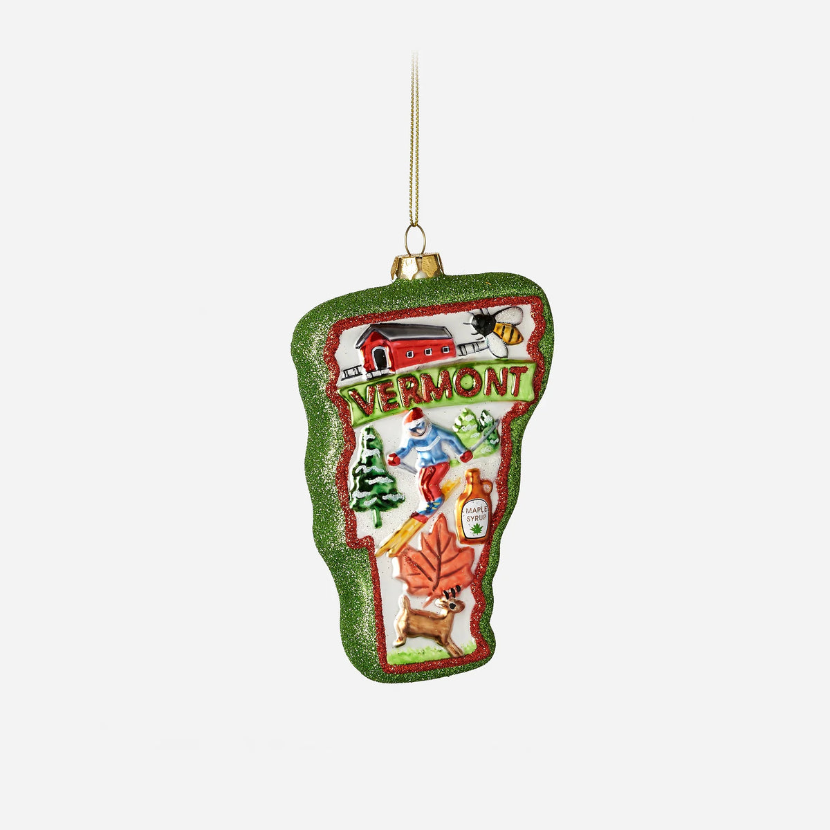 Decorative ornament shaped like Vermont with winter activities on a white background