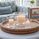 Simon Pearce Nantucket Hurricanes on a tray on an ottoman in a living room at Addison West