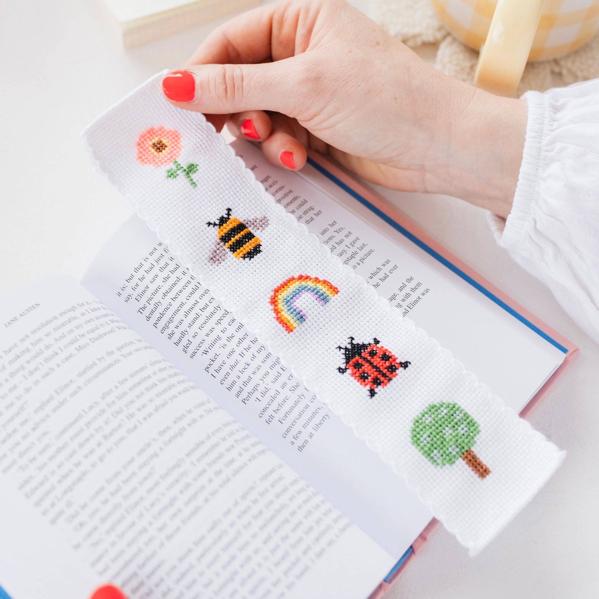 Nature Rainbow Cross Stitch Bookmark Kit in a book at Addison West