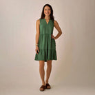 Nellie Dress in Dark Grass shown on model on plain background.