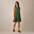 Nellie Dress in Dark Grass shown on model on plain background.