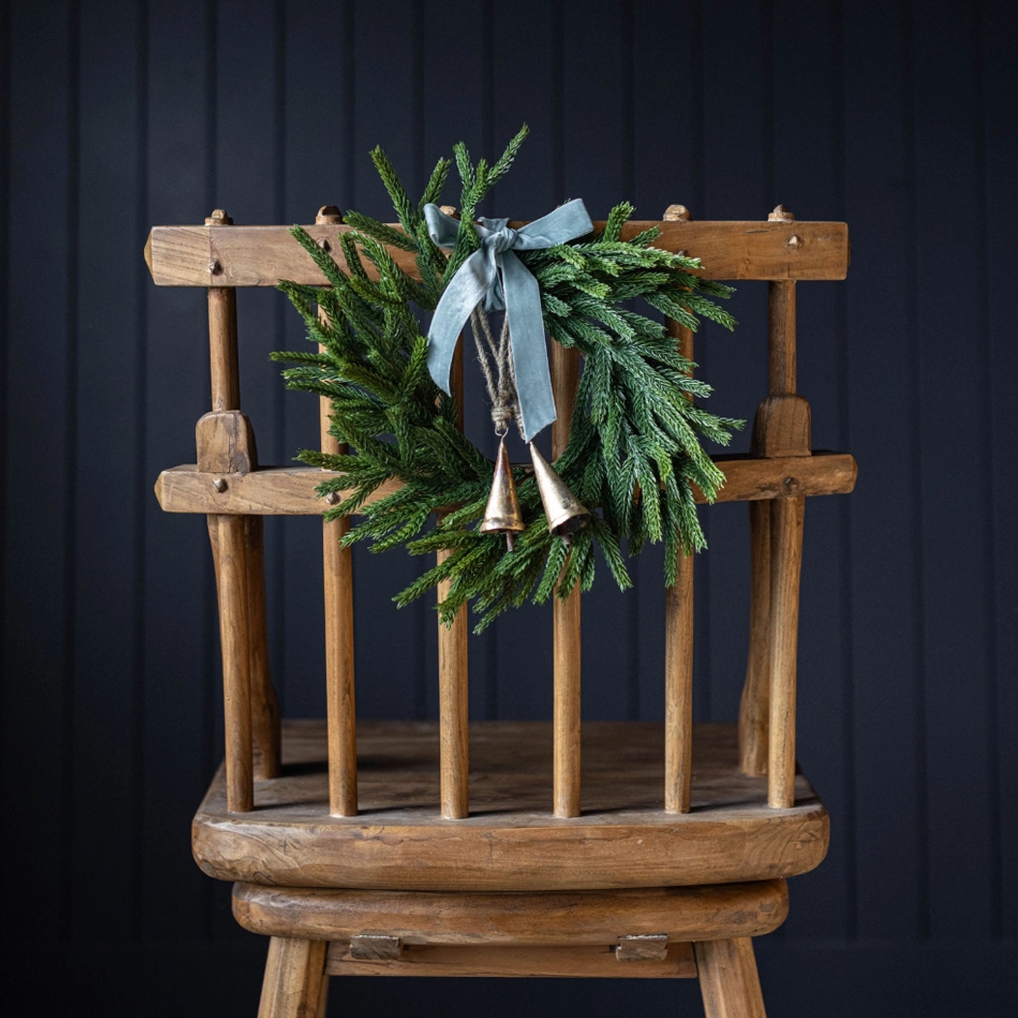 Norfolk & Cypress Mixed Real Touch Mini Wreath, 12" on a chair at Addison West