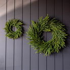 Norfolk & Cypress Mixed Real Touch Mini Wreath, 12" on a black wall at Addison West