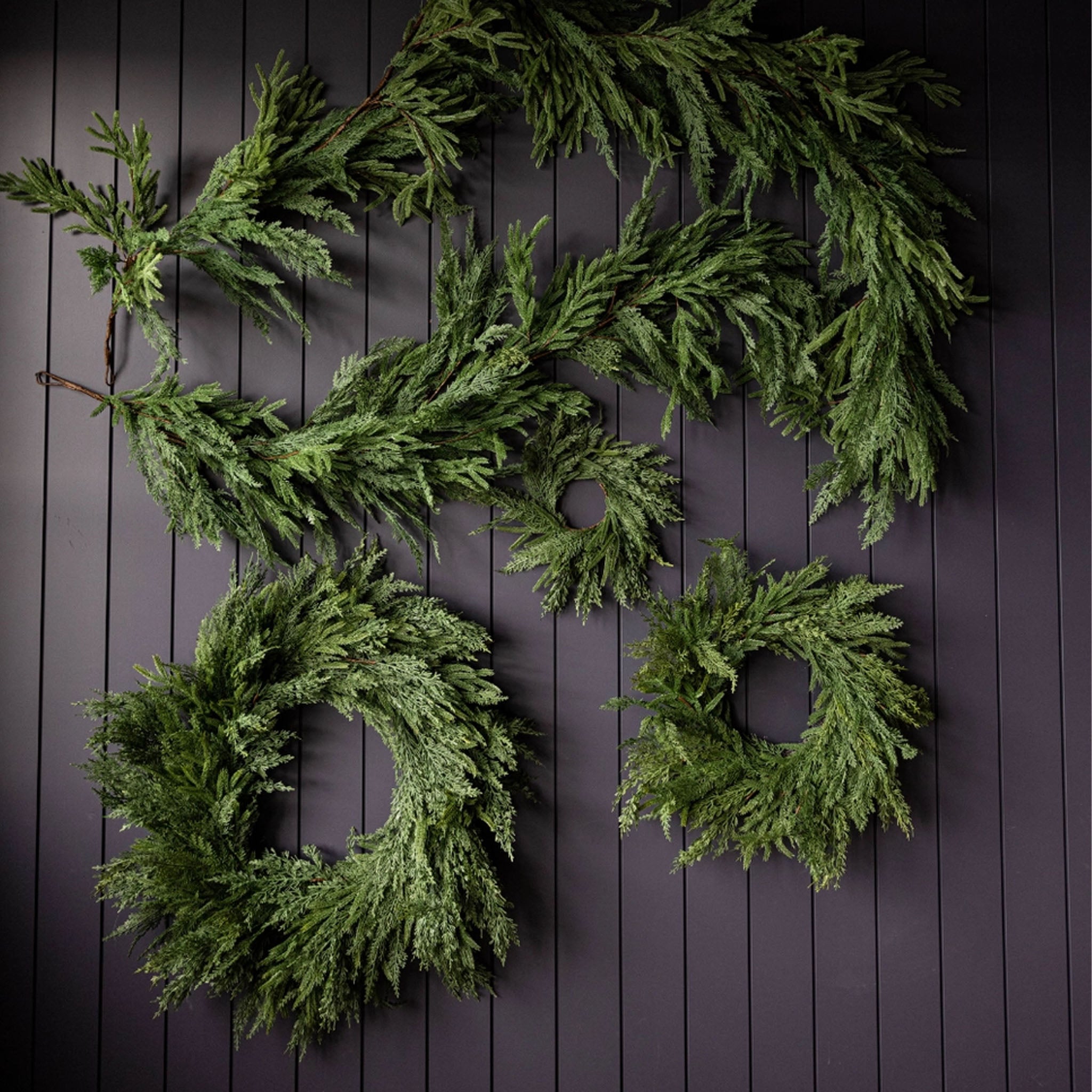 Norfolk & Cypress Mixed Real Touch Wreath, 34" in front of a black wall at Addison West