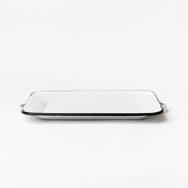 White enamel tray with black edge and handles on a white background