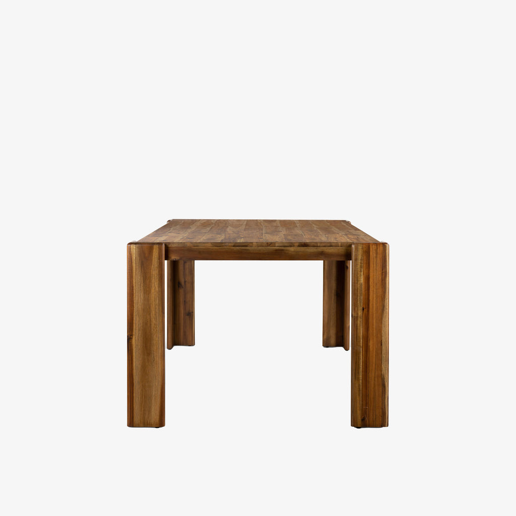 Four Hands Orla farmhouse style dining table in toasted acacia wood on a white background
