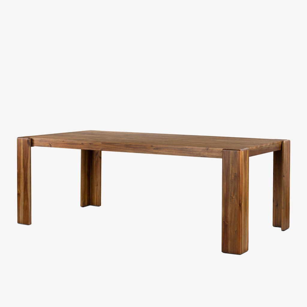 Four Hands Orla farmhouse style dining table in toasted acacia wood on a white background