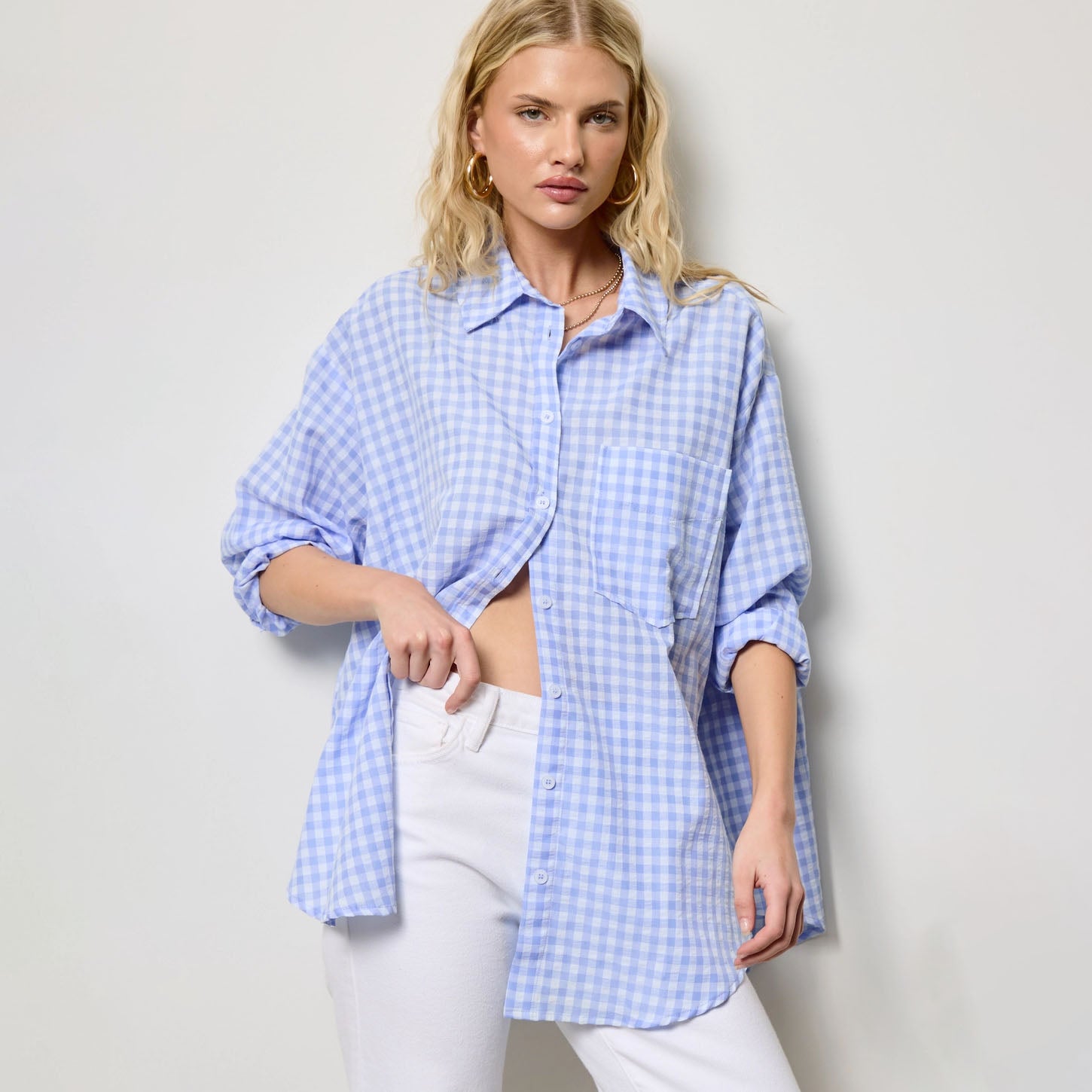 Oversized Gingham Buttom Down in Light Blue shown on model on plain background.