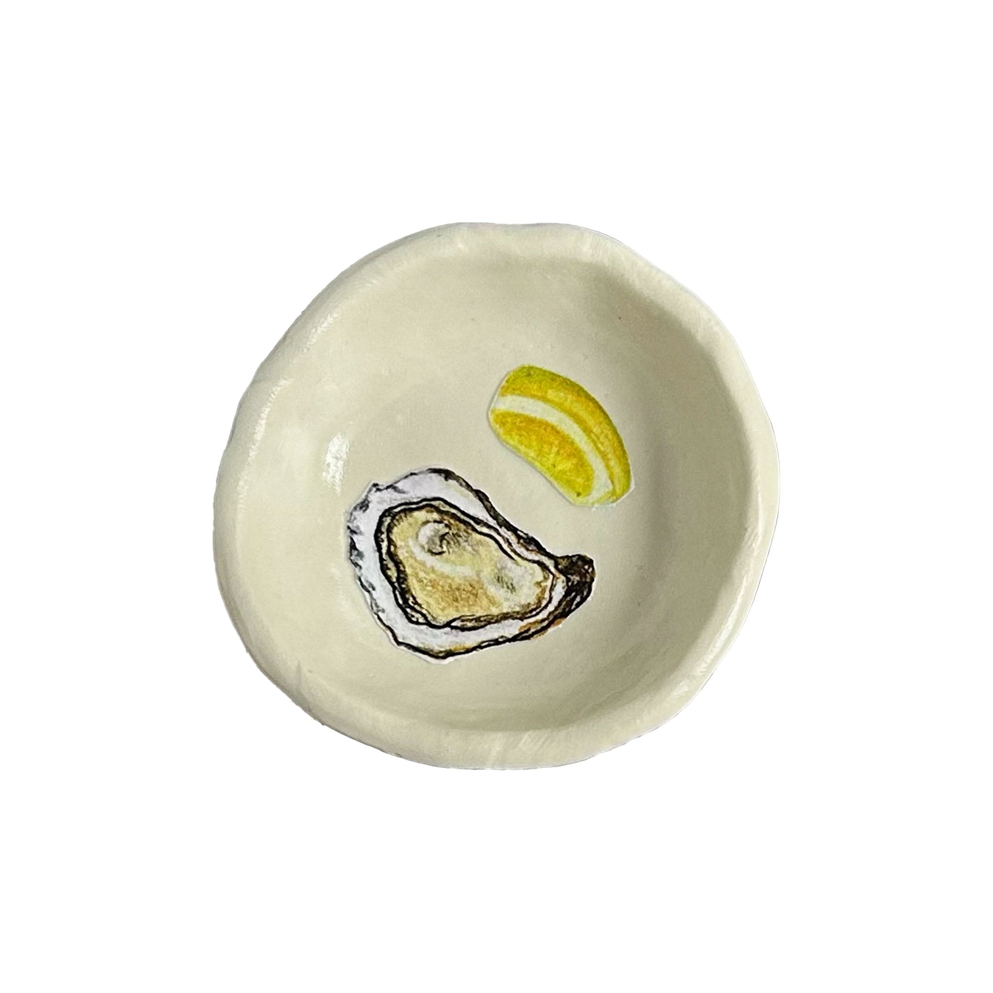Handmade clay dish with hand painted Oyster and Lemon on a white background