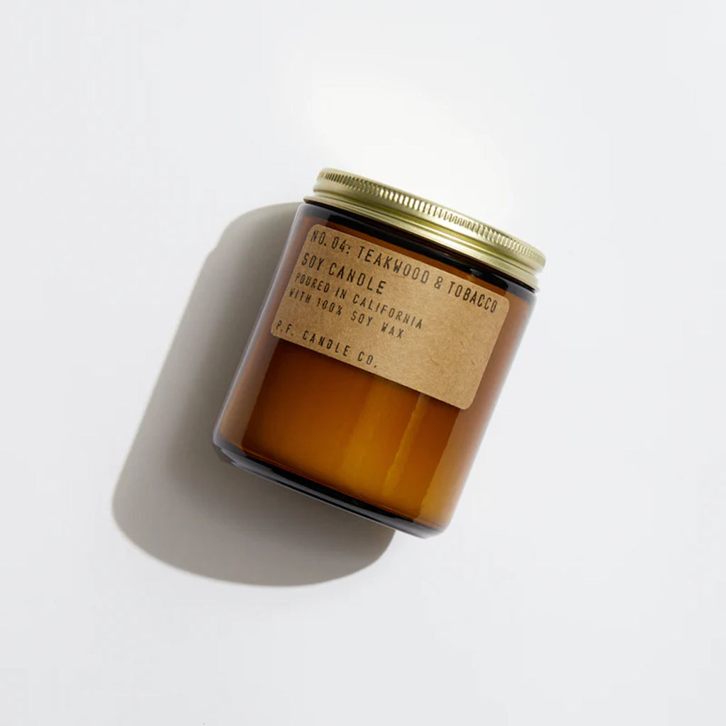 Brown jar of PF Candle Teakwood + Tobacco Candle on a white background