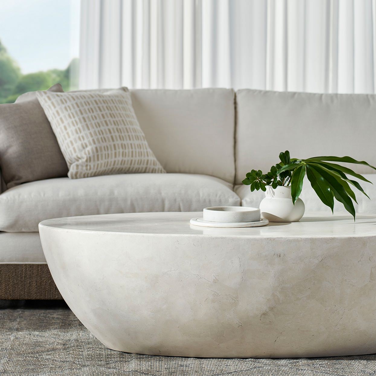 Palecek Vail Outdoor Stone Coffee Table in living room at Addison West.