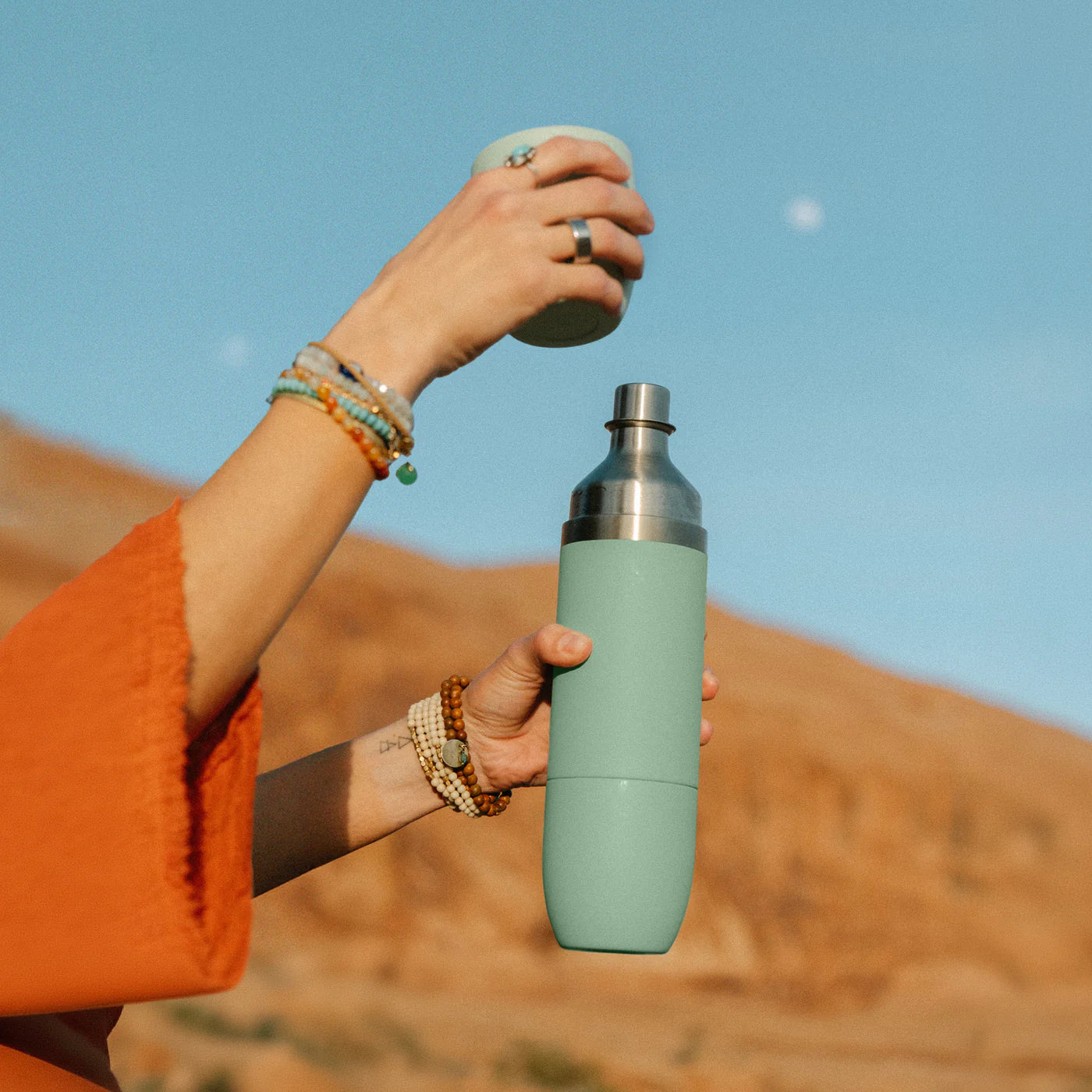 High Camp Parkside Flask in Juniper Green held by a model at Addison West