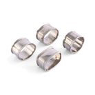 Set of four pewter napkin rings on a white background