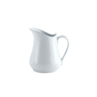 A white porcelain creamer pitcher with a handle and spout, against a plain background.