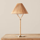 Delphine Table Lamp on a beige background and a wood table
