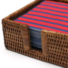 Caspari square rattan cocktail napkin holder with blue and red napkins on a white background