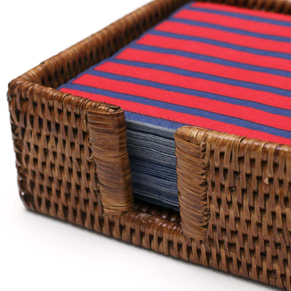 Caspari square rattan cocktail napkin holder with blue and red napkins on a white background