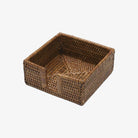 Caspari square rattan cocktail napkin holder on a white background