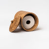 Rattan toilet paper holder with lid on a white background