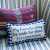 Furbish brand needlepoint pillow with saying 'my favorite thing to make for dinner is reservations' on a blue stripe chair 